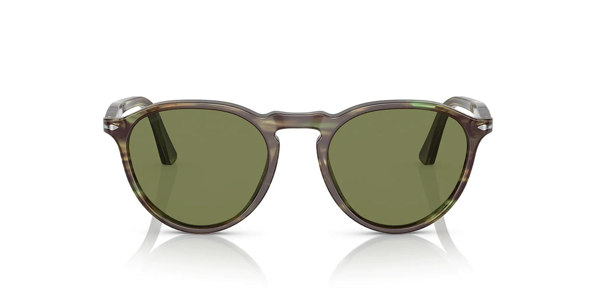 Sunglasses with green lenses and tortoise frame on a white background