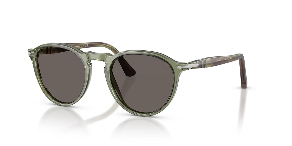 Green sunglasses with dark lenses on a white background