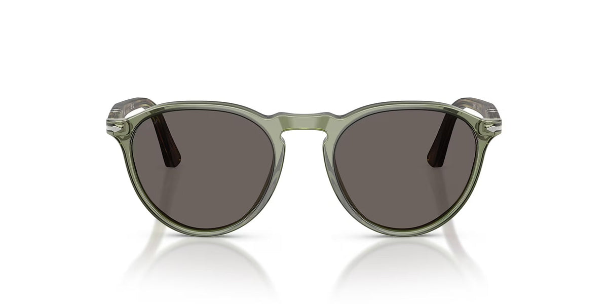 Sunglasses with green frames and dark lenses on a white background