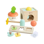 A Classic World wooden toy set arranged, including a shape sorter box, a fruit-shaped toy, a hammer, a sorting board, small pegs, and a card.