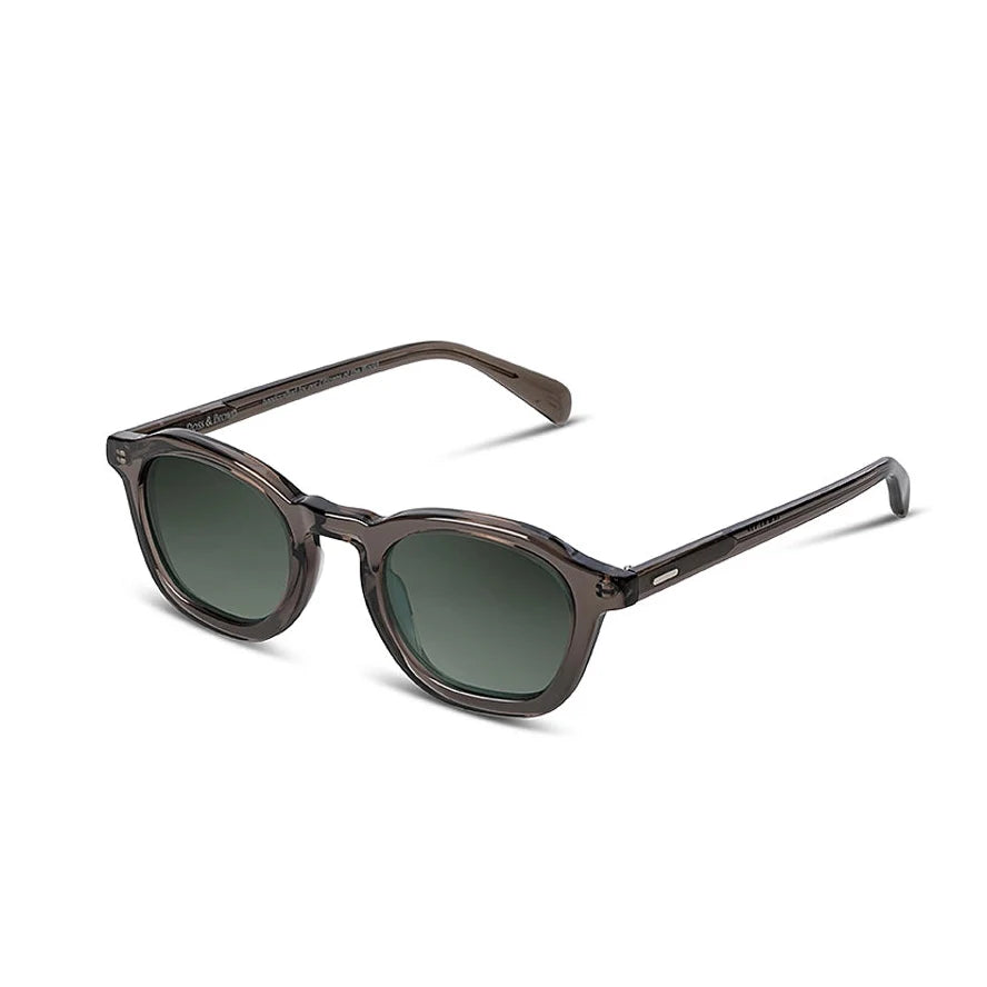 Sunglasses with dark frames and green lenses on a white background