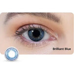Close-up of an eye wearing a blue contact lens with 'Brilliant Blue' label.