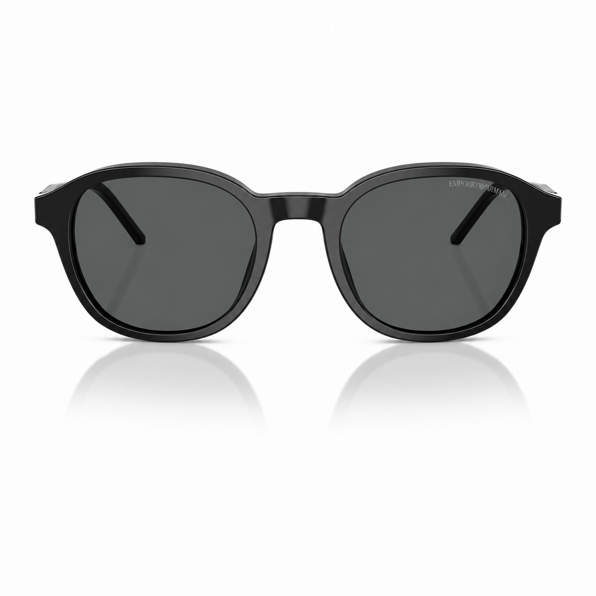 A pair of round-frame sunglasses with a glossy black acetate frame and dark gray lenses, shown from the front on a white background with a soft reflection below.
