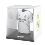 Real Madrid jersey in a clear display case with visible branding.