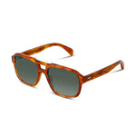 Side angle of tortoiseshell framed sunglasses with dark lenses on a white background.  