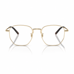 Gold metal eyeglass frames with a thin hexagonal shape and dark brown acetate temple tips, shown on a clean white background with a soft reflection.