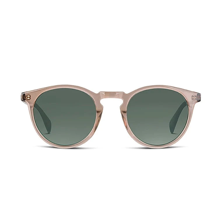 Round sunglasses with a translucent blush pink frame and dark green lenses, shown from the front on a plain white background.