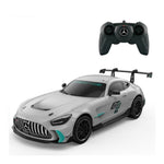 A silver Mercedes-Benz GT-R style remote control toy car with black wheels and teal accents, shown with a black remote control controller above it on a white background.