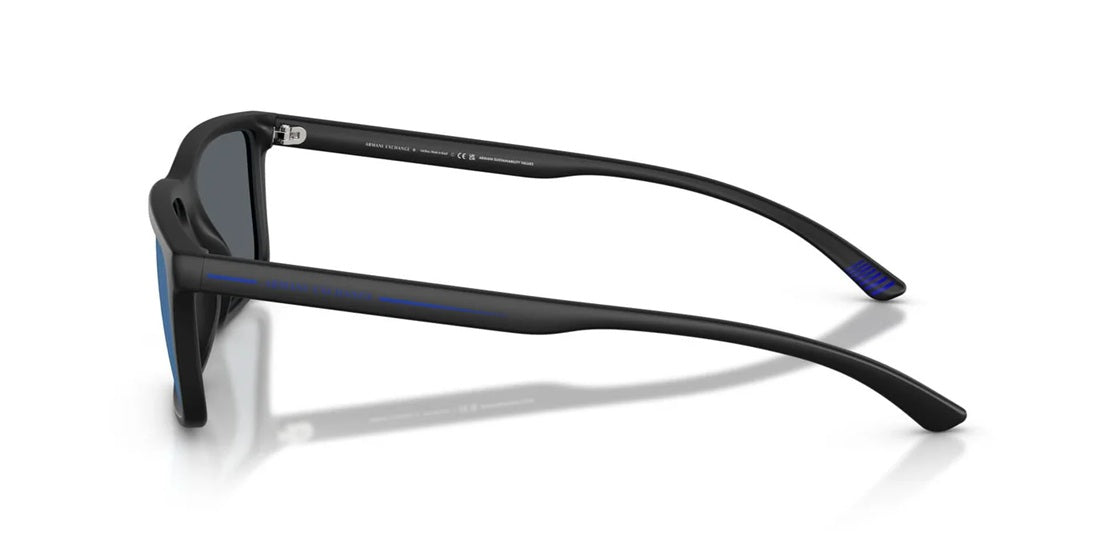 Side angle of dark rectangular glasses with blue lenses on a white background.