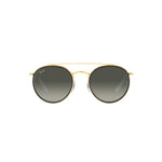 Round sunglasses with gold frame and dark lenses 
