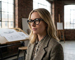 Side angle of a woman wearing black framed eyeglasses. 