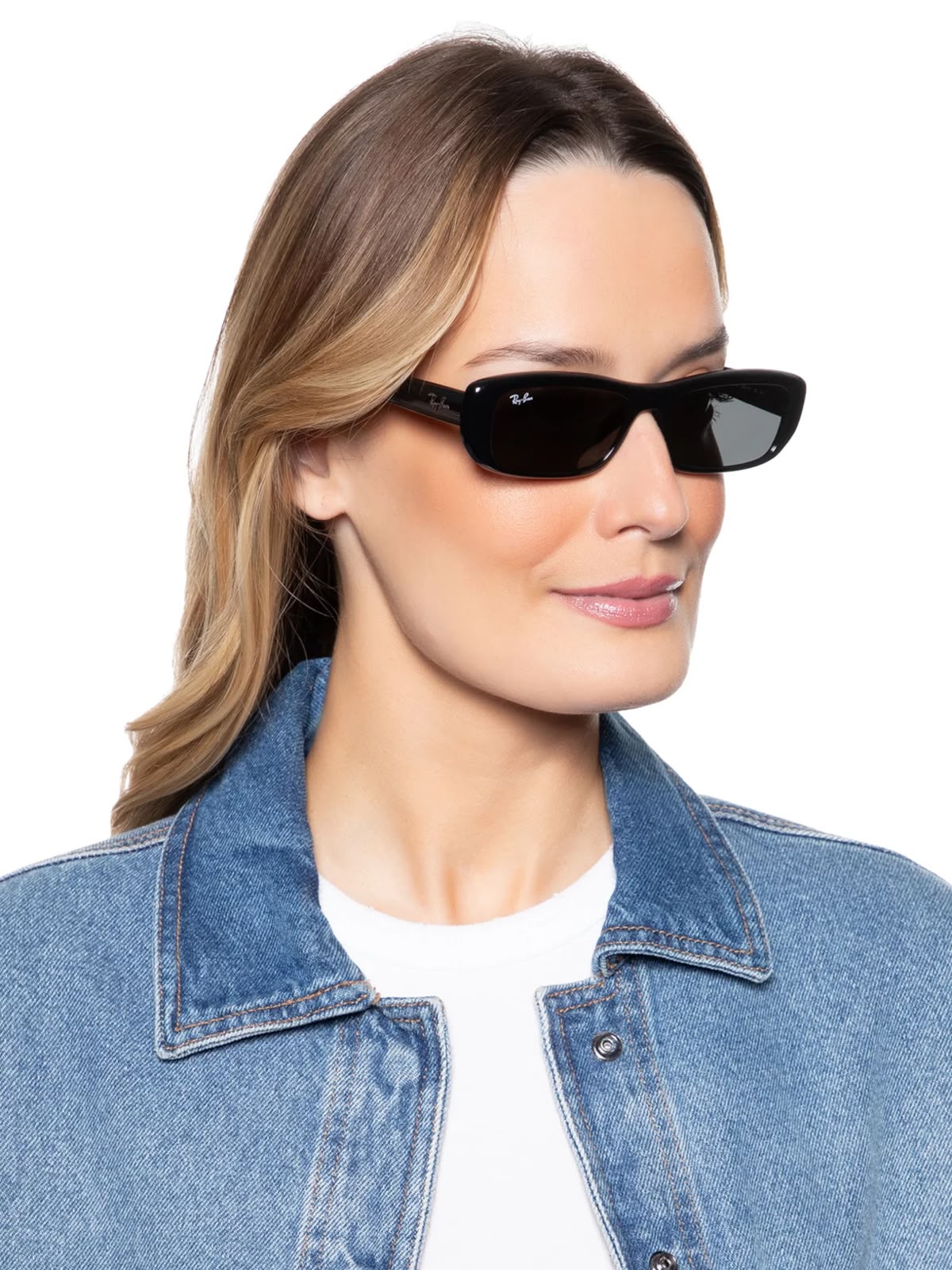 Side angle of a woman wearing black sunglasses on a white background. 