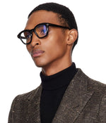 Side angle of a man wearing black eyeglasses on a white background. 