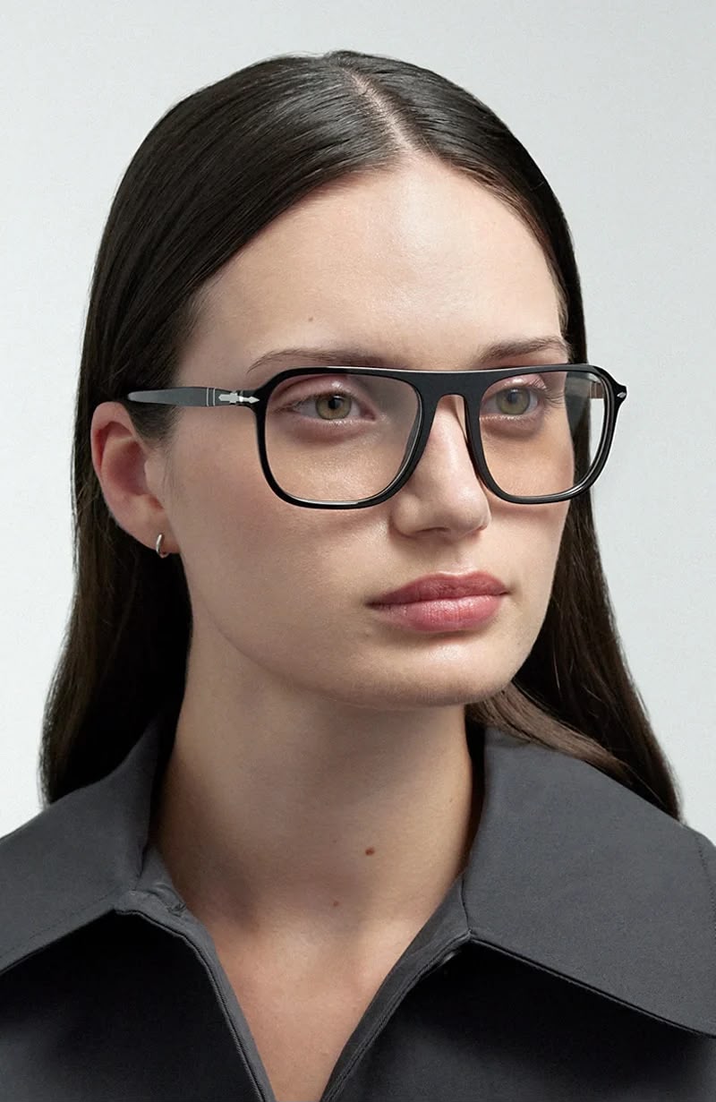 Side angle of a woman wearing black framed eyeglasses. 