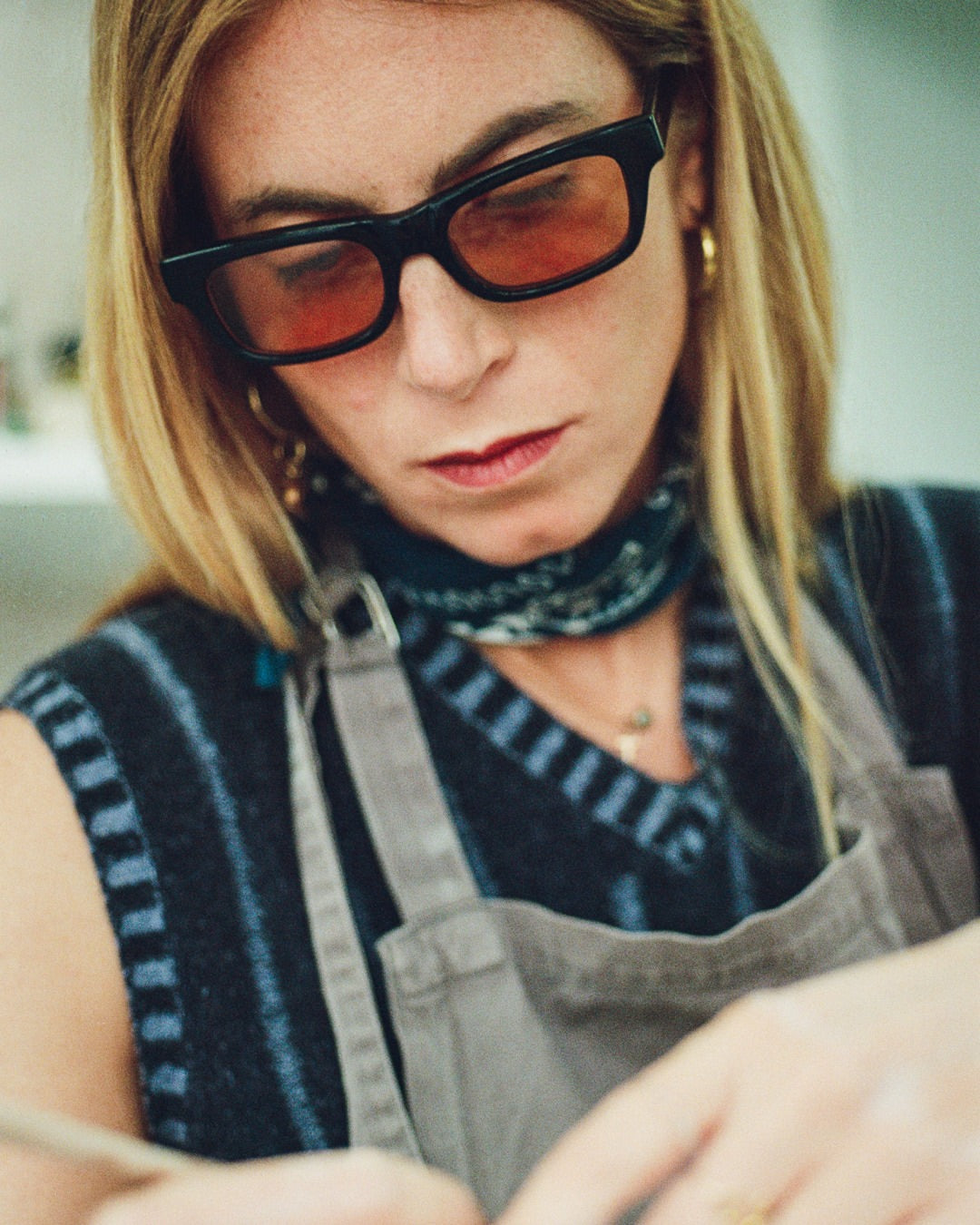 A woman wearing black framed sunglasses.