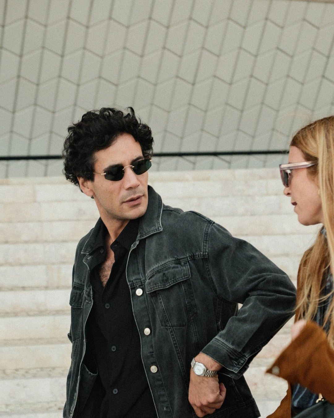 Side angle of a guy wearing sunglasses with dark lenses. 